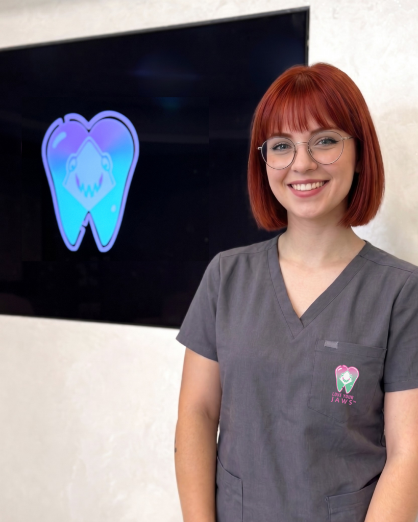 A team member, smiling in front of a screen with LYJ Logo