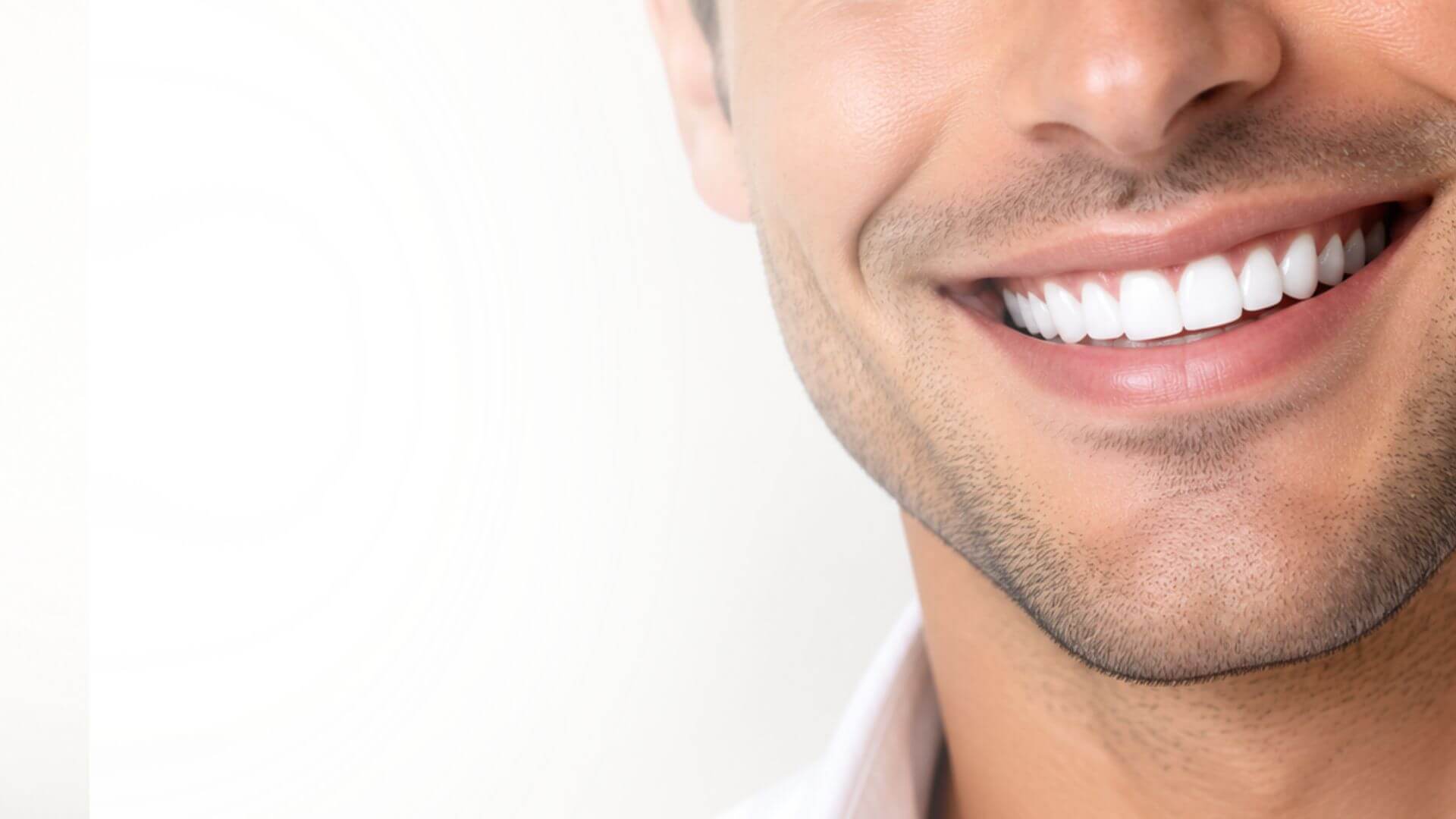 Confident male patient with a bright white smile representing advanced dental and oral surgery care at Love Your Jaws Surgery Center in Miami, Florida.